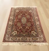 A machine made rug of Iranian design,