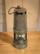 An antique miner's safety lamp