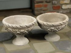 A pair of concrete urn planters,