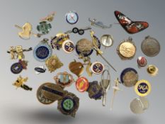 A collection of silver and other badges.