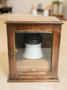 A Victorian glazed oak smoker's cabinet with ceramic jar,