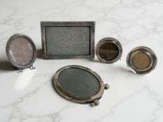 Five silver-mounted photo frames, largest 14cm wide.