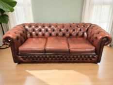 A Chesterfield Oxblood buttoned leather three seater club settee,