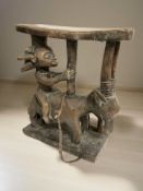 An African carved wooden figural headrest,