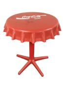 A fibre glass occasional table in the form of a Coca-cola cap,