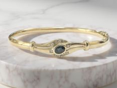 A 9ct yellow gold sapphire and diamond bangle, 60 mm x 53 mm CONDITION REPORT: 6.