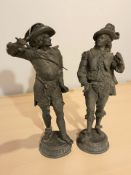A pair of patinated metal figures of swordsmen,