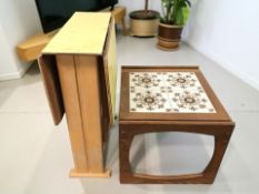 A vintage melamine drop leaf kitchen table together with a tile inset teak lamp table