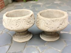 A pair of concrete acanthus leaf pedestal planters,