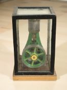 A live steam stationary piston engine in glazed case,