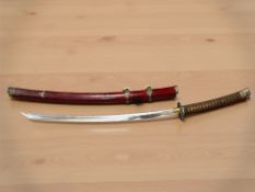 A 20th century Japanese katana in red lacquer saya