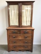 An Art Nouveau oak five drawer chest 106 cm x 50 cm x 102 cm together with a non matching glazed