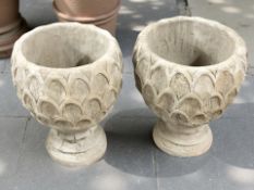A pair of concrete garden pineapple planters,