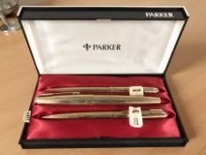 A Parker gold plated fountain pen with 14ct gold nib with a matching ballpoint pen and propelling