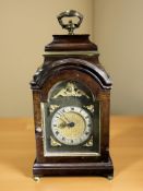 A mahogany mantel timepiece in the form of a Georgian bracket clock,