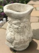 A concrete garden toby jug planter,