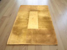 A contemporary machine made rug on yellow ground,