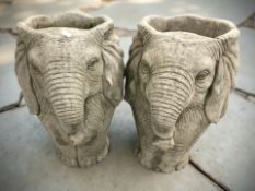 A pair of composition garden planters in the form of elephants,