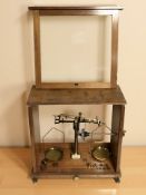 A set of Baird & Tatlock brass scales in glazed case,