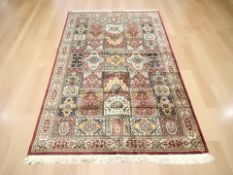 A machine made rug of Iranian design,