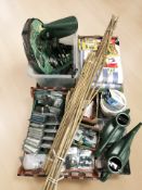 New garden supplies including watering cans, metal wall brackets, lenghts of bamboo,