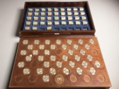 A coin collector's cabinet containing Danbury Mint uncirculated Presidential one dollar coins