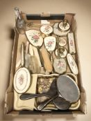 A collection of petit point dressing table brushes, jars, faux tortoiseshell mirrors,