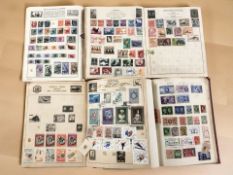 Four vintage stamp albums and contents