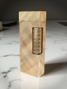 A Dunhill 9ct gold cigarette lighter with engine turned decoration, London 1963, height 6.5cm.