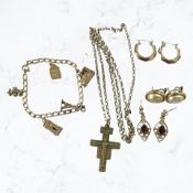 A group of gold plated and yellow metal jewellery items including charm bracelet,
