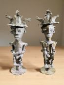 A pair of West African bronze statues of seated figures,