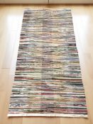 A contemporary multi coloured rug labelled 'House Doctor',