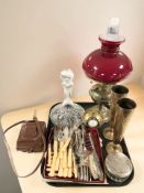 A brass oil lamp with red glass shade, ships decanter, pair of Indian engraved brass tapering vases,