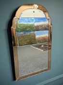 An Art Deco two tone peach glass wall mirror,