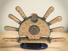 A decorative Indian set of carving knives and forks on painted stand,