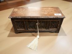A miniature carved oak coffer with key,