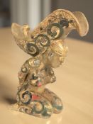 An Oriental gilt metal and enamelled vessel in the form of a kneeling figure,