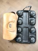 A set of Henselite lawn bowls in case and a further leather bowls case