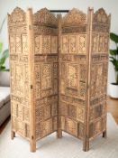 An Indian heavily carved hardwood four fold screen,