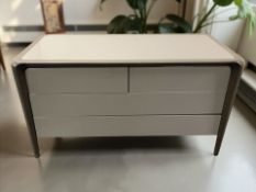 A contemporary high gloss four drawer chest, 130 cm x 58 cm x 71 cm,