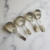 Three Georgian silver spoons (two Thomas Watson, Newcastle) and a Victorian caddy spoon.