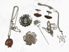 A group of silver/white metal items including amber pendant and pair of cuff links, niello brooch,