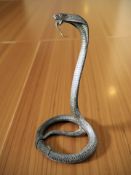 A patinated bronze statue of a coiled cobra,