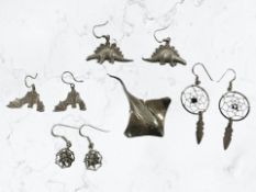 Four pairs of novelty earrings, in the form of dinosaurs, bats, spider webs, and dream catchers,