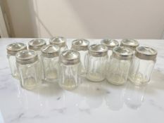 Twelve silver topped miniature glass jars, height 3.