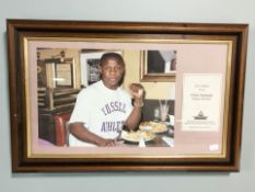 A framed photograph of Chris Eubank with a signed card,