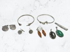 A bangle with cat terminals, stamped Silver, together with a group of silver cuff links,