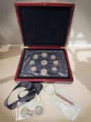 A coin collector's box containing an enameled Elizabeth II pre-decimal coin set,