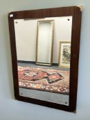 A contemporary mirror on a hardwood board, 78 cm x 109 cm.