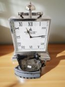 A chrome battery operated timepiece with carry handle, height 43 cm,